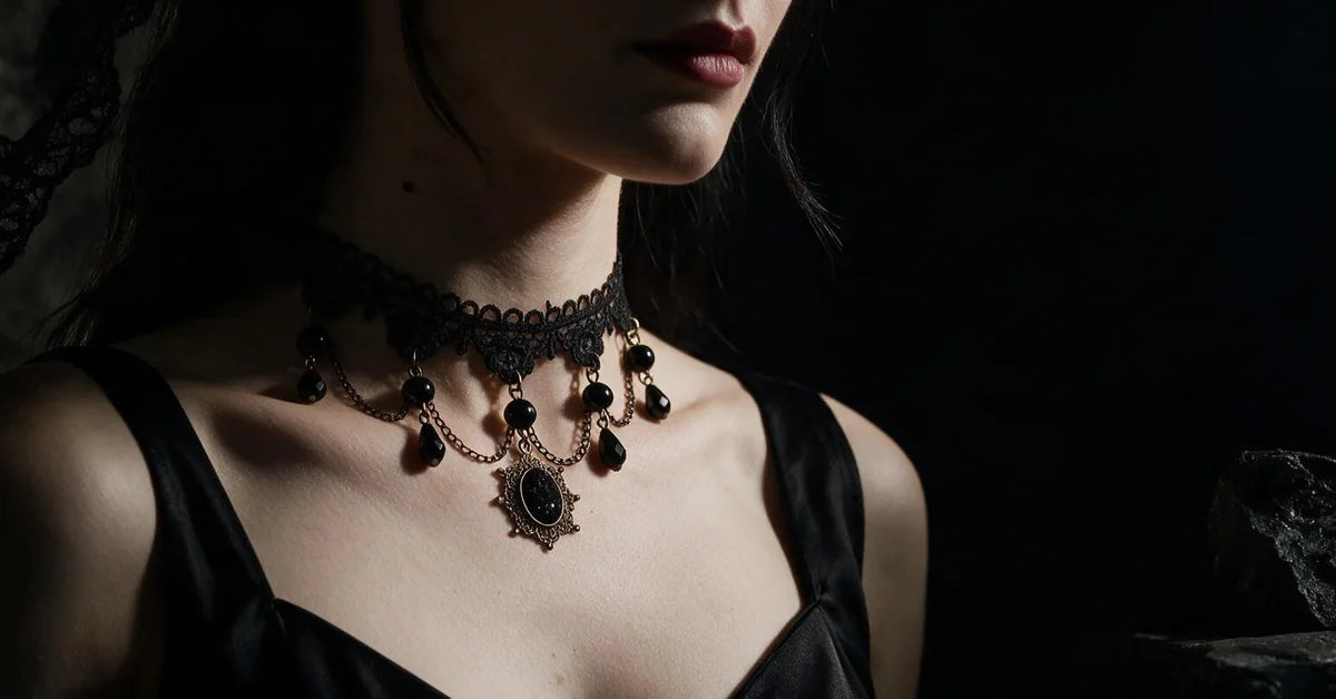 Gothic jewelry: black lace choker necklace with antique bronze chains worn by a model in a black dress