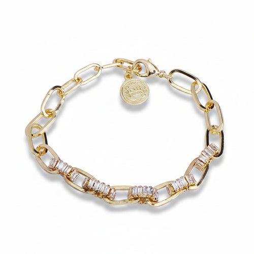 Gold plated copper paperclip chain bracelet with baguette zirconia-paved oval links, lobster clasp and engraved coin charm pendant, coiled on white background with soft drop shadow

