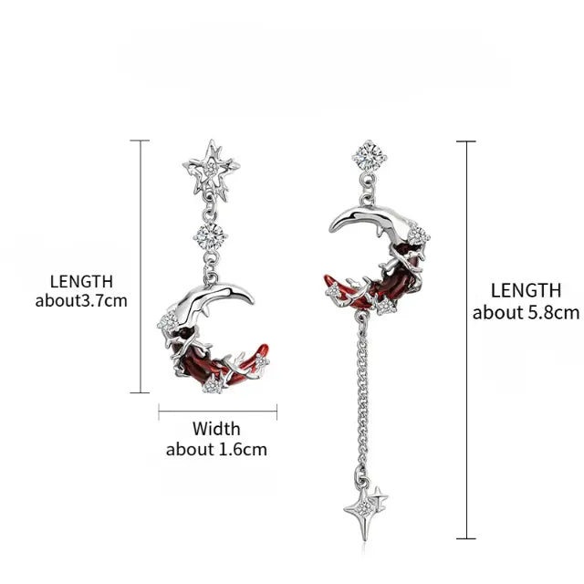 Asymmetric silver-tone moon and star drop earrings size reference: left short crescent moon earring approximately 3.7cm length and 1.6cm width; right long crescent moon earring with chain and spike star drop approximately 5.8cm length; white background with measurement annotations

