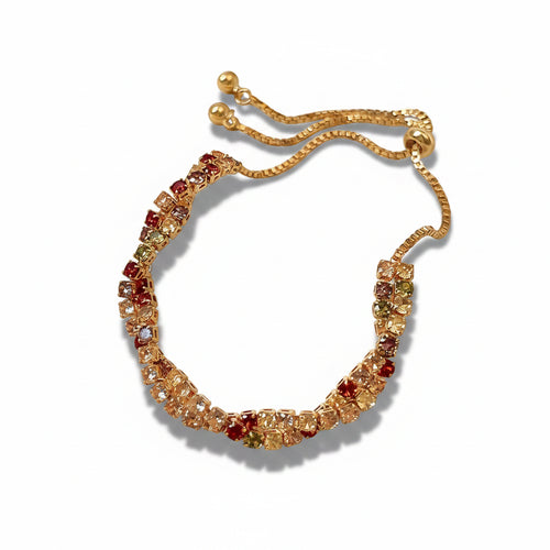 Gold plated copper adjustable drawstring tennis bracelet with multicolor round zirconia stones in red, champagne, olive green and clear settings, coiled on white background showing gold box chain drawstring closure with two gold ball ends, soft drop shadow

