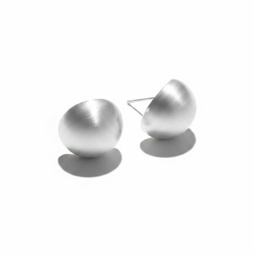 Pair of silver-tone brushed matte dome stud earrings with stud post backs, isolated on white background with directional shadow

