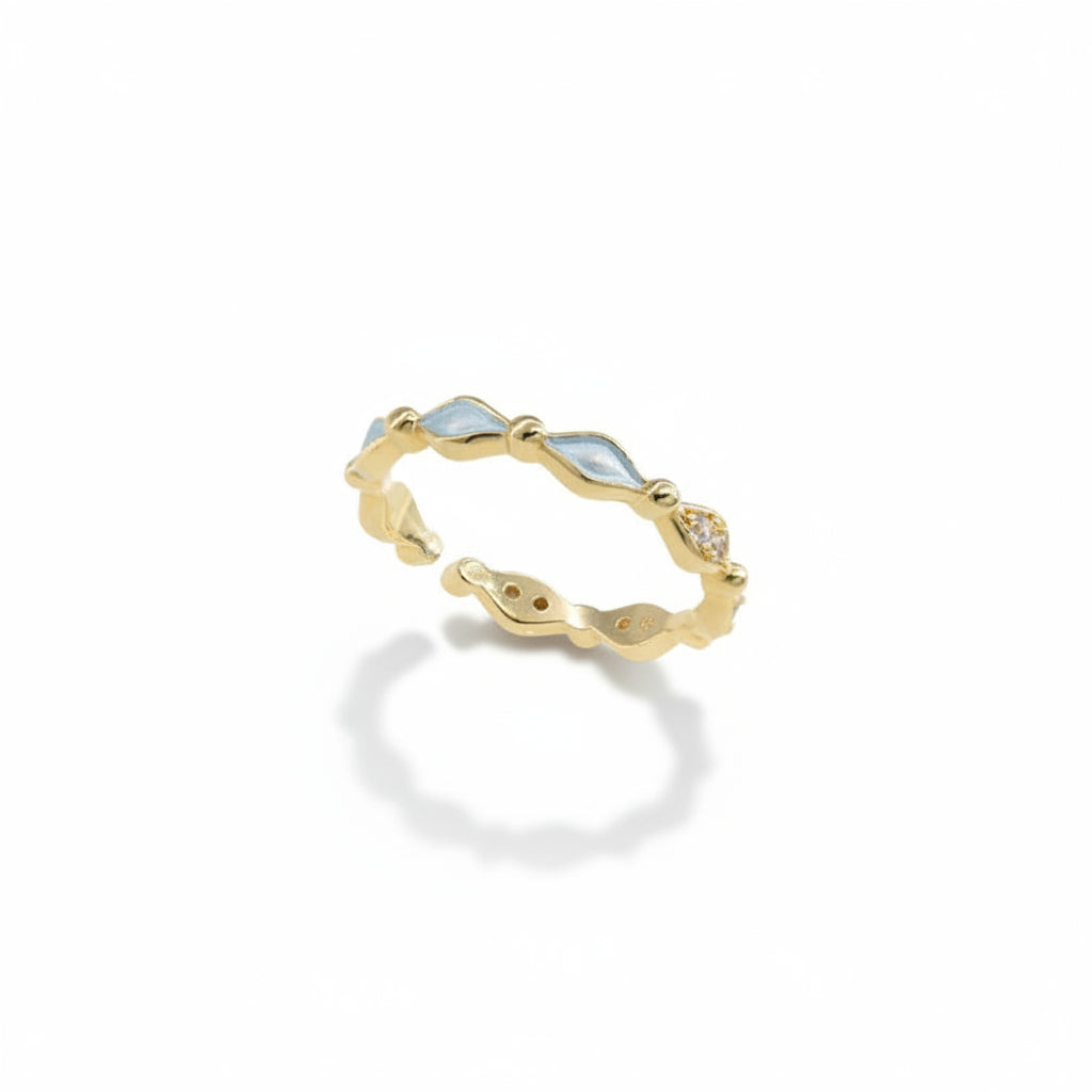 Gold alloy adjustable open band ring with alternating light blue diamond-shaped enamel, gold bead connectors, and clear zirconia accent, isolated on white background with soft drop shadow

