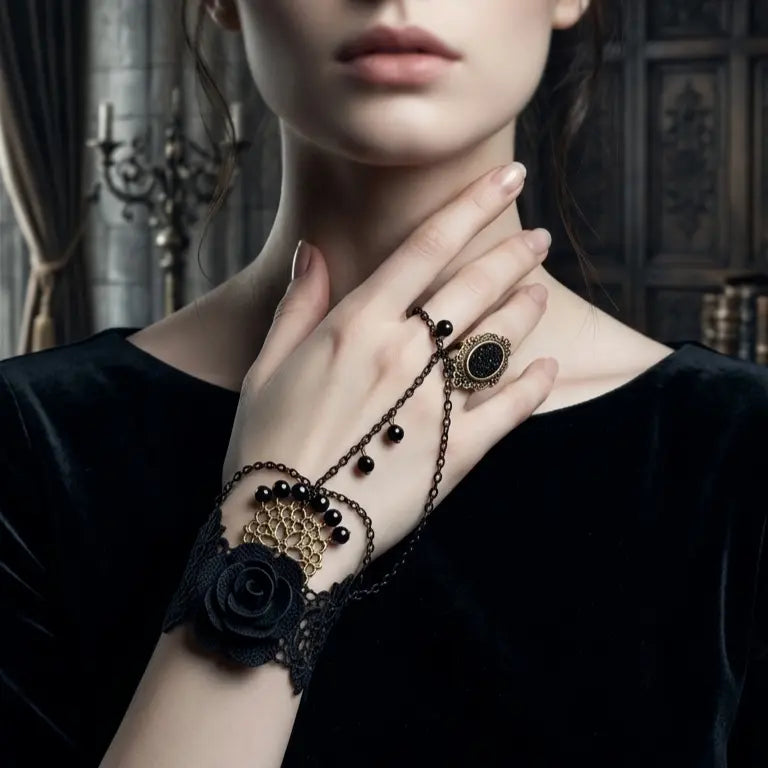 Woman with light skin tone and dark updo wearing gothic black lace rose onyx slave bracelet ring set — black fabric rose wrist cuff with antique bronze mesh, black bead drops and connected filigree black onyx ring — hand touching neck, black velvet square-neck top, dark gothic library with candelabra background, AI-generated model image

