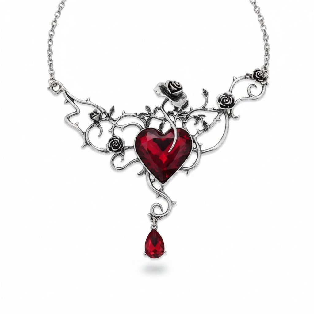 Gothic silver-tone antique alloy rose vine thorn filigree necklace with large faceted deep red heart crystal centerpiece and red teardrop crystal drop pendant, four sculpted rose buds along vine frame, silver rolo chain, isolated on white background with soft drop shadow

