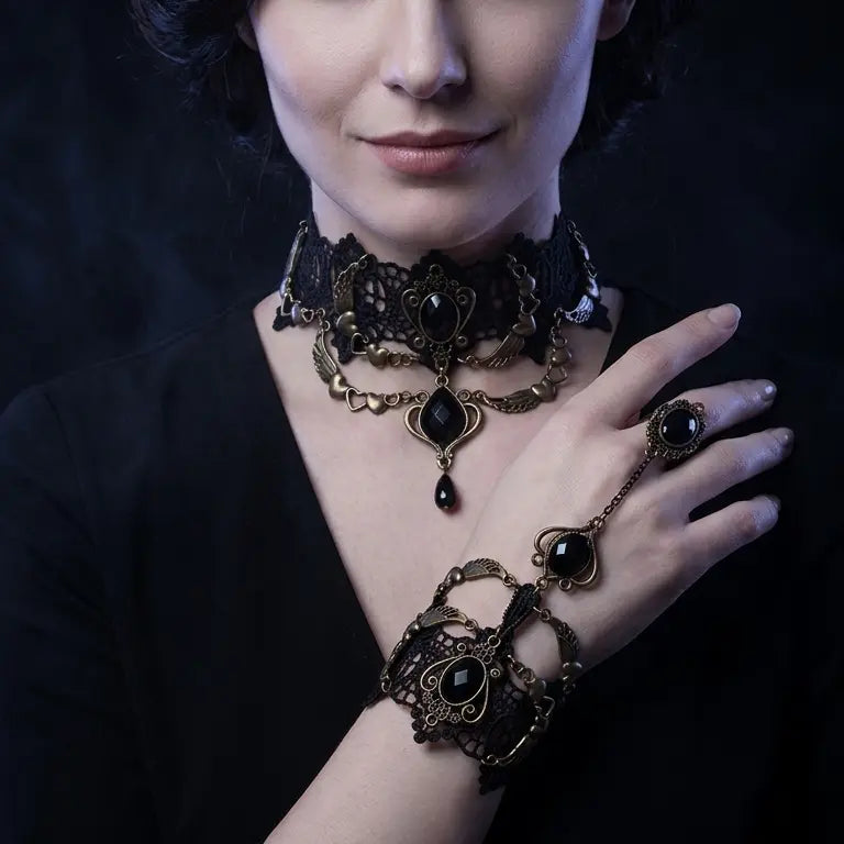 Woman with light skin tone and dark updo wearing gothic black lace angel wing onyx slave bracelet ring set on wrist and finger, paired with matching gothic black lace angel wing onyx choker necklace at neck, black top, dark smoky black background — bracelet ring set shown as part of coordinated gothic jewelry set


