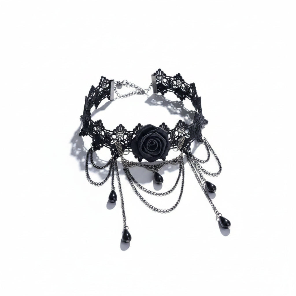 Gothic black lace floral filigree wide choker necklace with 3D black rose centerpiece, metal leaf accents, multiple draped gunmetal chains and five black teardrop bead drops, magnetic clasp and extender chain visible, isolated on white background with directional shadow